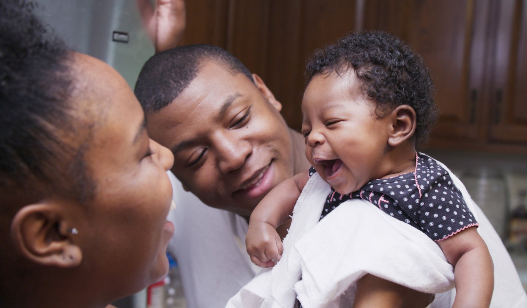 baby smiling at parents
